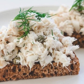 rockfish salad on whole wheat bread and dill sprig garnish